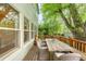 Spacious wooden deck showcasing an outdoor dining area with wicker chairs and tranquil backyard views at 677 N Gilpin St, Denver, CO 80218