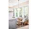 Bright dining area featuring a round wooden table, stylish chandelier, and built-in banquette seating at 677 N Gilpin St, Denver, CO 80218