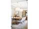 Elegant dining room showcasing modern pendant lighting, ample seating around a wooden table, and natural lighting at 677 N Gilpin St, Denver, CO 80218