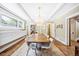 Open dining room area features a wooden table for eight and modern pendant lights providing a welcoming place to gather at 677 N Gilpin St, Denver, CO 80218