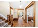 Spacious hallway with hardwood floors, decorative rug on the staircase, and multiple entryways, adding to the home's charm at 677 N Gilpin St, Denver, CO 80218