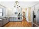 Modern kitchen featuring two-tone cabinets, stainless steel appliances, and stylish lighting at 677 N Gilpin St, Denver, CO 80218