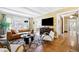 Inviting living room featuring hardwood floors, coffered ceiling, stylish furniture, and ample natural light creating a comfortable space at 677 N Gilpin St, Denver, CO 80218