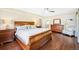 Comfortable main bedroom with wood floors, matching dresser and nightstand, and a cozy armchair at 677 N Gilpin St, Denver, CO 80218