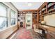 Well-lit home office with built-in bookshelves, large window, desk, and decorative rug, perfect for a workspace at 677 N Gilpin St, Denver, CO 80218