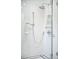 Close-up of a modern shower with chrome fixtures, white tile, and a glass enclosure at 677 N Gilpin St, Denver, CO 80218