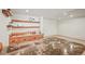 Basement bar area features a sink, shelving, warm wood cabinets, granite countertops, and a spacious design at 9868 Overlook Rd, Sedalia, CO 80135