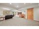 Spacious basement featuring a seating area, wood burning stove, built-in bar, door, and carpeted floors at 9868 Overlook Rd, Sedalia, CO 80135