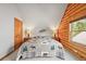 Bedroom featuring log walls, a quilt bedspread, and a view of the outdoors at 9868 Overlook Rd, Sedalia, CO 80135