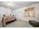 Cozy bedroom featuring a comfy bed, wood trim, carpeted floors, and a bright window offering natural light at 9868 Overlook Rd, Sedalia, CO 80135