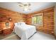 Cozy bedroom with log walls, soft lighting, and a peaceful ambiance at 9868 Overlook Rd, Sedalia, CO 80135