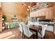Bright dining room with hardwood floors, vaulted ceiling, and log walls near the kitchen and living areas at 9868 Overlook Rd, Sedalia, CO 80135