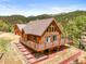 Charming log home featuring a spacious deck, natural wood finishes, and mountain views at 9868 Overlook Rd, Sedalia, CO 80135