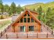 Log home with a large deck, many windows, and beautiful mountain views offering a serene and picturesque setting at 9868 Overlook Rd, Sedalia, CO 80135