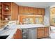 Kitchen offering wood cabinets and a granite breakfast bar that looks into the dining room at 9868 Overlook Rd, Sedalia, CO 80135