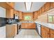 Well-lit kitchen with updated appliances, wood cabinets, and granite countertops at 9868 Overlook Rd, Sedalia, CO 80135