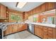 Kitchen with wood cabinets, tiled floors, lots of counterspace and an open view to dining room at 9868 Overlook Rd, Sedalia, CO 80135