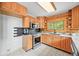 Galley kitchen featuring stainless steel appliances, wood cabinets and modern countertops at 9868 Overlook Rd, Sedalia, CO 80135