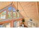 Lofted living room featuring wood ceiling, large windows providing scenic views, and cozy lighting at 9868 Overlook Rd, Sedalia, CO 80135