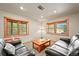 Living area featuring two leather sofas, a wood framed window, and a wood coffee table at 9868 Overlook Rd, Sedalia, CO 80135