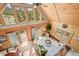 Overhead view of a living room featuring wood ceiling, large windows with scenic views and a fireplace at 9868 Overlook Rd, Sedalia, CO 80135
