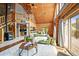Open-concept living space with a log-beamed ceiling, gas fireplace, and natural light at 9868 Overlook Rd, Sedalia, CO 80135