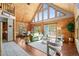 Inviting living room with vaulted ceilings, large windows, and cozy fireplace at 9868 Overlook Rd, Sedalia, CO 80135