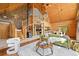 Spacious living room featuring wood paneled walls, staircase, and an inviting open floor plan at 9868 Overlook Rd, Sedalia, CO 80135