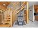 Unique staircase features log beams, stone wall accents, and a warm, inviting ambiance at 9868 Overlook Rd, Sedalia, CO 80135