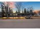 Stunning single-story home with sleek lines, mature trees and inviting curb appeal at sunset at 456 Cherry St, Denver, CO 80220