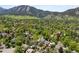 Aerial perspective of neighborhood homes, surrounded by lush greenery and nestled against the backdrop of majestic mountains at 1020 10Th St, Boulder, CO 80302