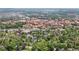 Aerial view highlighting residential area surrounded by lush greenery and distant buildings at 1020 10Th St, Boulder, CO 80302