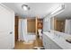 Well-lit bathroom features a shower-tub combo, a single sink vanity, and modern fixtures on wood look floor at 1020 10Th St, Boulder, CO 80302