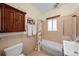 Neutral-toned bathroom featuring a bathtub with glass doors, vanity and neutral tile at 1020 10Th St, Boulder, CO 80302
