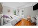 Bright bedroom with hardwood floors, large windows, and a cozy single bed. Desk and chair as well at 1020 10Th St, Boulder, CO 80302