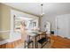 Bright dining room with hardwood floors, modern black table and bench seating, and open floorplan at 1020 10Th St, Boulder, CO 80302