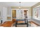 Bright dining room with hardwood floors, built-in shelves, and modern black table and bench seating at 1020 10Th St, Boulder, CO 80302