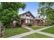 Charming Tudor-style home with a well-manicured lawn and mature trees at 1020 10Th St, Boulder, CO 80302