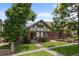 Charming Tudor-style home with a well-manicured lawn and mature trees at 1020 10Th St, Boulder, CO 80302