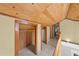 Hallway with wooden ceiling and trim, doors leading to rooms and storage at 1020 10Th St, Boulder, CO 80302
