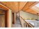 Hallway with wooden ceiling and trim, showcasing natural light from the upper level at 1020 10Th St, Boulder, CO 80302