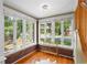 Cozy sun room with ample windows, brick accents, hardwood floors, and neighborhood views at 1020 10Th St, Boulder, CO 80302