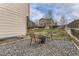 Backyard space with a fire pit, gravel area, and wooden seating, perfect for outdoor gatherings at 20910 Omaha Ave, Parker, CO 80138