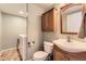 Practical bathroom featuring a vanity sink, toilet, and storage cabinet, alongside laundry setup for added convenience at 20910 Omaha Ave, Parker, CO 80138