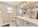Bright bathroom with modern finishes, featuring double sinks, granite countertops, and elegant marble tiling at 20910 Omaha Ave, Parker, CO 80138