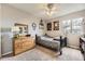 Cozy bedroom featuring a wooden dresser, a comfortable bed, and a large window with natural light at 20910 Omaha Ave, Parker, CO 80138