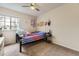 Bright bedroom with a ceiling fan, window and a bed decorated with colorful pillows and whimsical decor at 20910 Omaha Ave, Parker, CO 80138