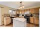 Functional kitchen featuring wooden cabinets, stone backsplash, stainless appliances, and a practical kitchen island at 20910 Omaha Ave, Parker, CO 80138