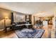 Open floor plan featuring a living room with large rug and kitchen, creating a welcoming and spacious living area at 20910 Omaha Ave, Parker, CO 80138