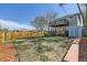 Large, fenced backyard with a two-story deck, storage shed, and wood benches at 3225 Olive St, Denver, CO 80207